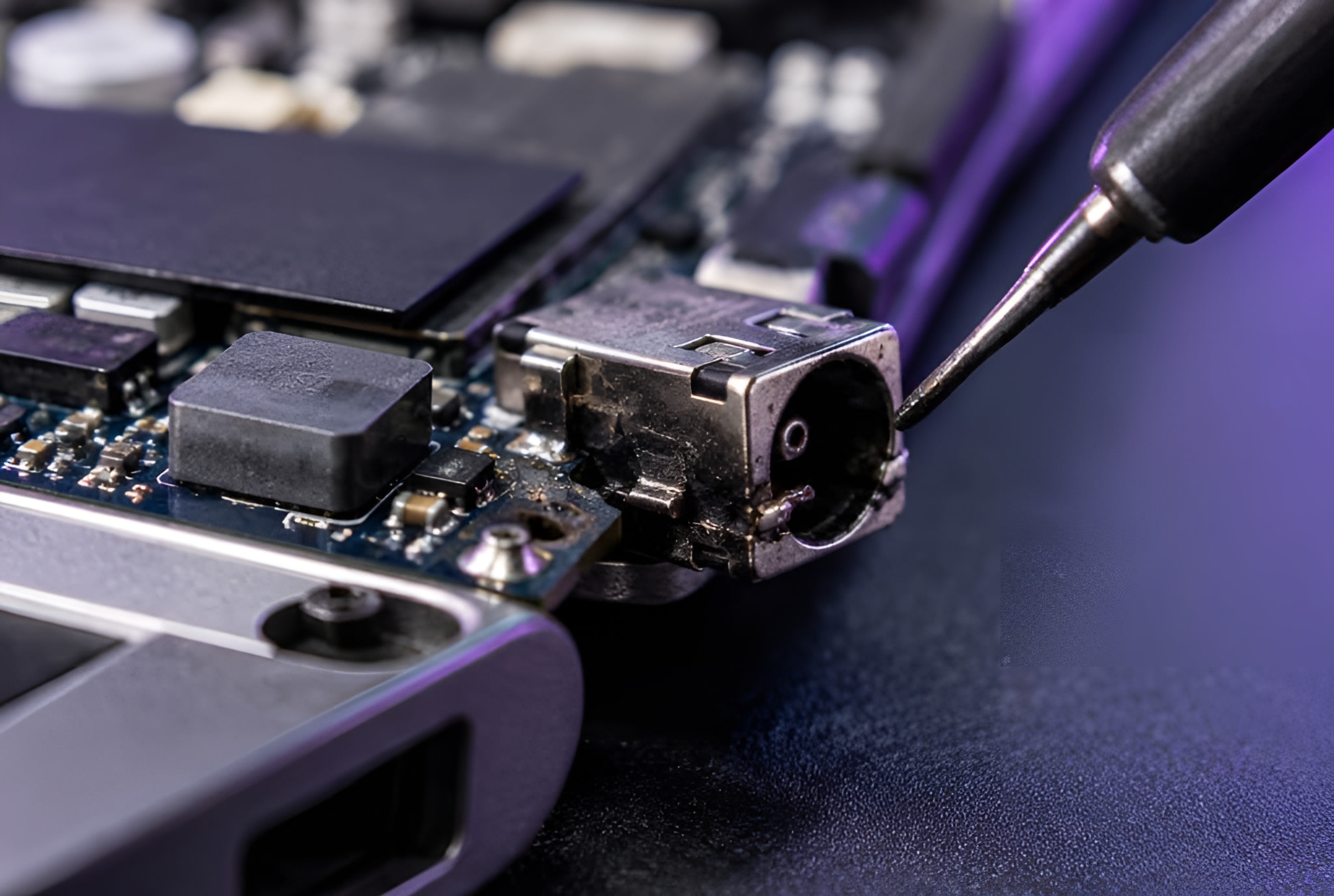 Laptop charging port being soldered